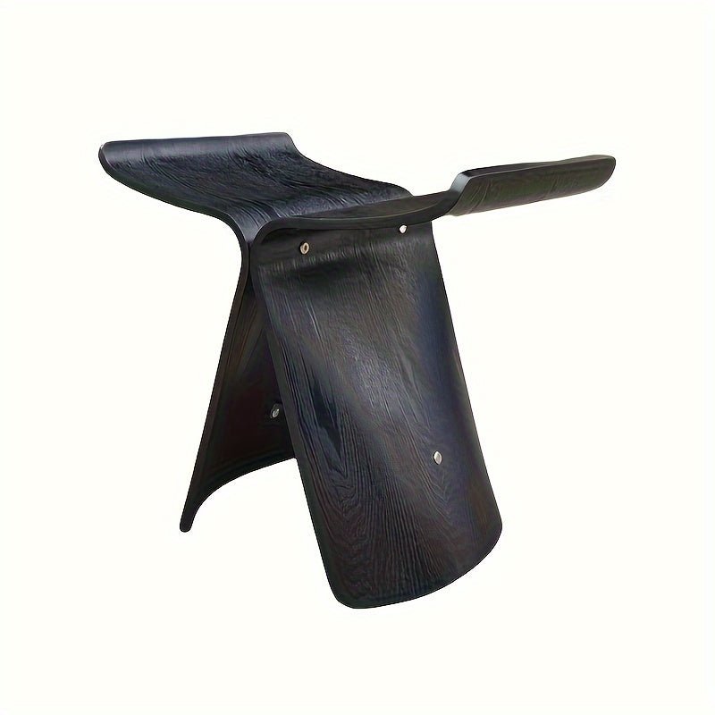 Solid wood butterfly stool with a natural finish, featuring a timeless design for compact and versatile seating in any space. 4
