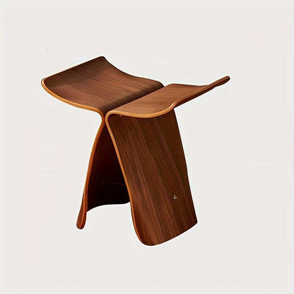 Solid wood butterfly stool with a natural finish, featuring a timeless design for compact and versatile seating in any space. 3