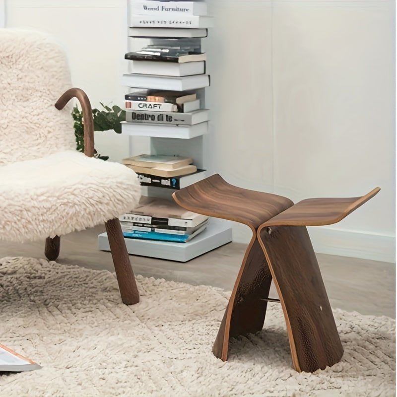 Solid wood butterfly stool with a natural finish, featuring a timeless design for compact and versatile seating in any space. 5