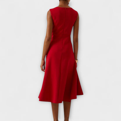 Sophisticated midi dress featuring an asymmetric detail and a stylish sleeveless design, perfect for elegant occasions. 1