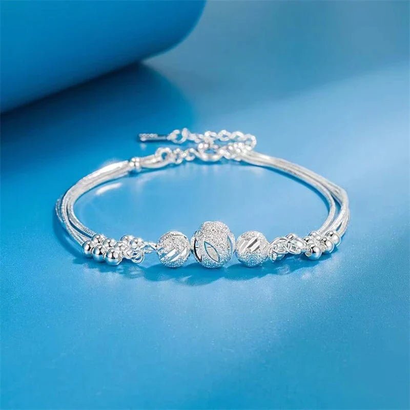 Sterling silver adjustable bracelet featuring symbolic charms for luck, measuring 20cm in length. 1