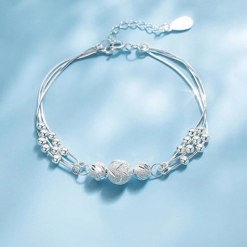 Sterling silver adjustable bracelet featuring symbolic charms for luck, measuring 20cm in length. 0