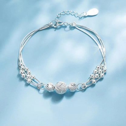 Sterling silver adjustable bracelet featuring symbolic charms for luck, measuring 20cm in length. 0