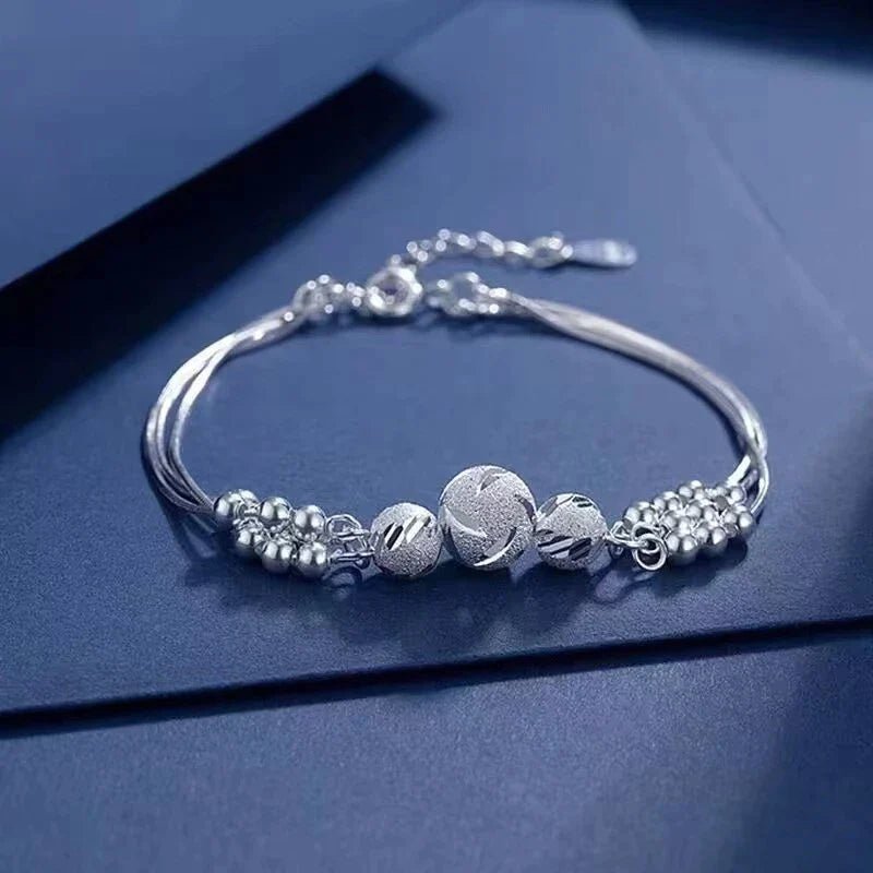 Sterling silver adjustable bracelet featuring symbolic charms for luck, measuring 20cm in length. 2