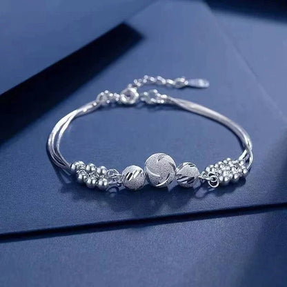 Sterling silver adjustable bracelet featuring symbolic charms for luck, measuring 20cm in length. 2