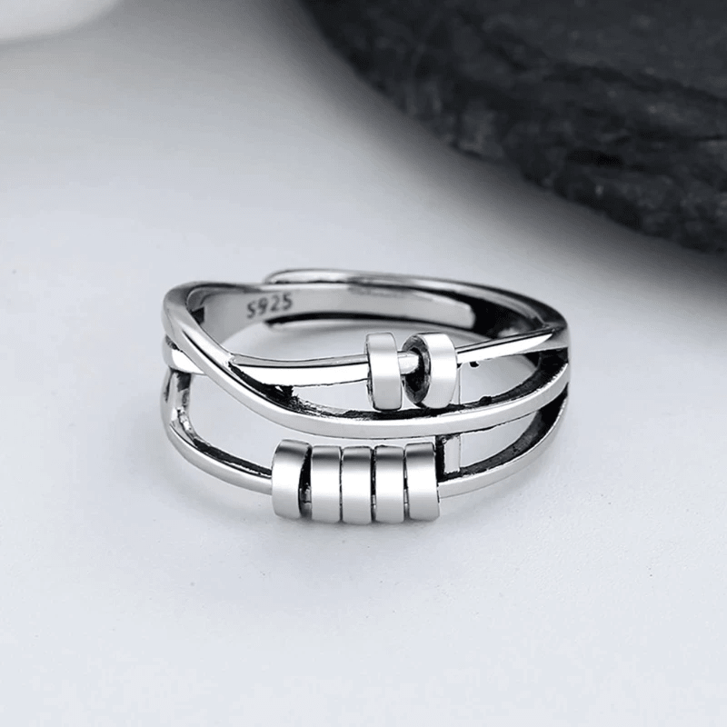 Sterling silver spinable anti-anxiety ring featuring an elegant design, adjustable size, and stress relief benefits, perfect for everyday wear. 0