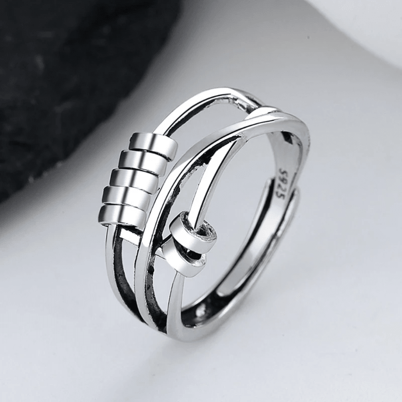 Sterling silver spinable anti-anxiety ring featuring an elegant design, adjustable size, and stress relief benefits, perfect for everyday wear. 1