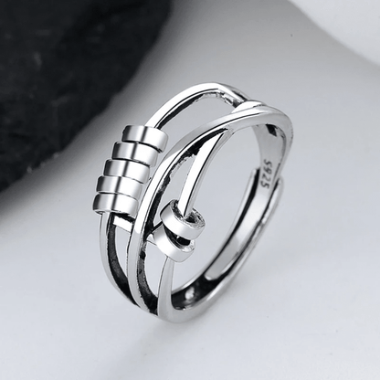 Sterling silver spinable anti-anxiety ring featuring an elegant design, adjustable size, and stress relief benefits, perfect for everyday wear. 1