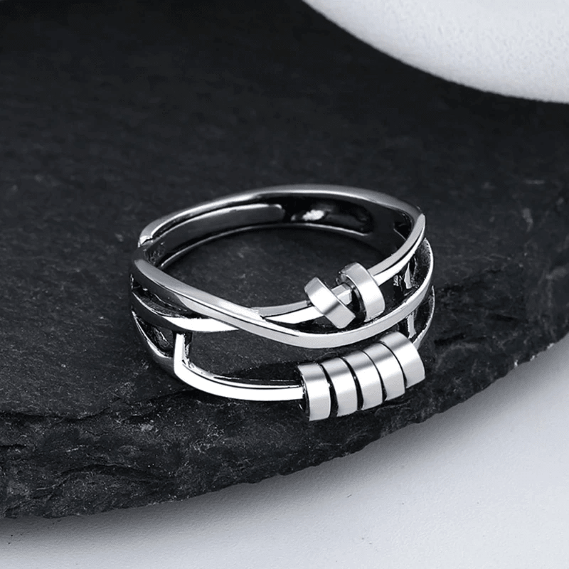 Sterling silver spinable anti-anxiety ring featuring an elegant design, adjustable size, and stress relief benefits, perfect for everyday wear. 2