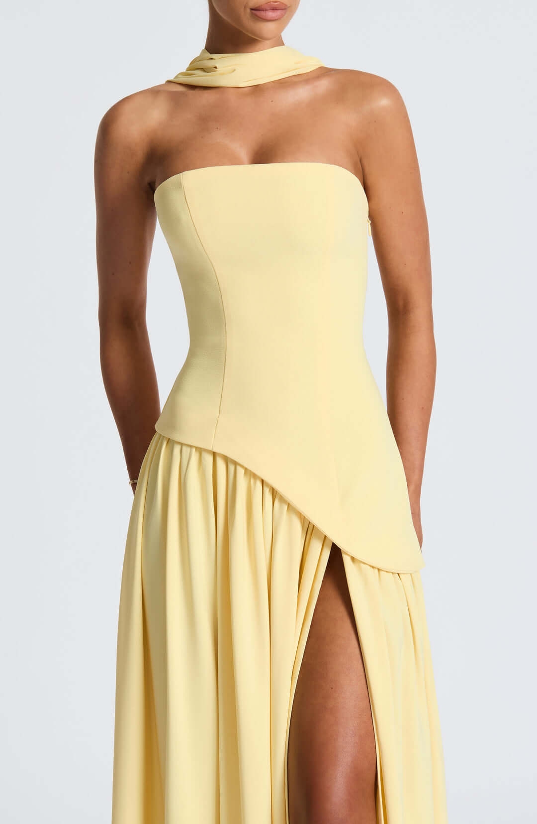 Strapless corset maxi gown featuring an asymmetrical draped skirt, perfect for elegant evening events and formal weddings. 5