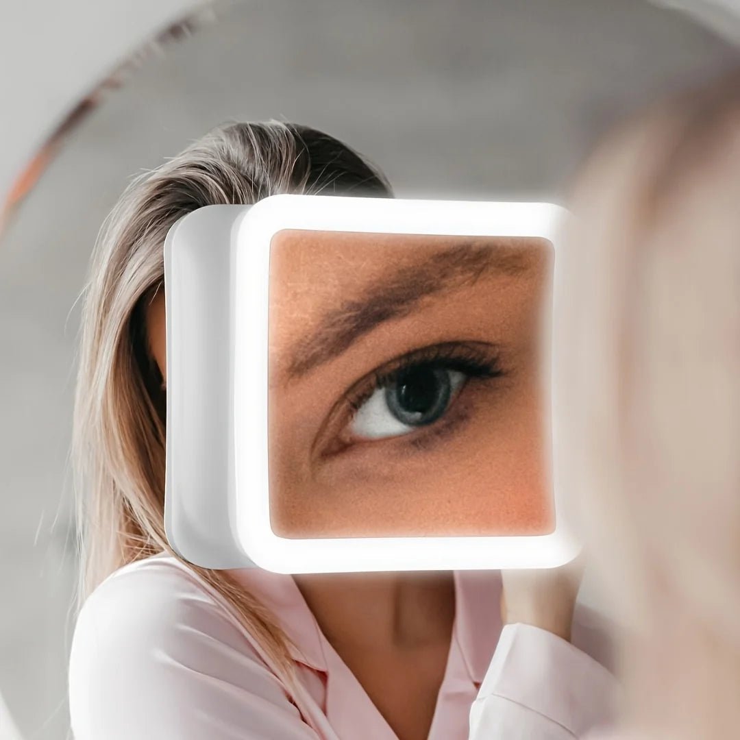 Suction cup makeup mirror featuring 10X magnification and dual LED lights, designed in white plastic and glass for a stylish vanity addition. 2