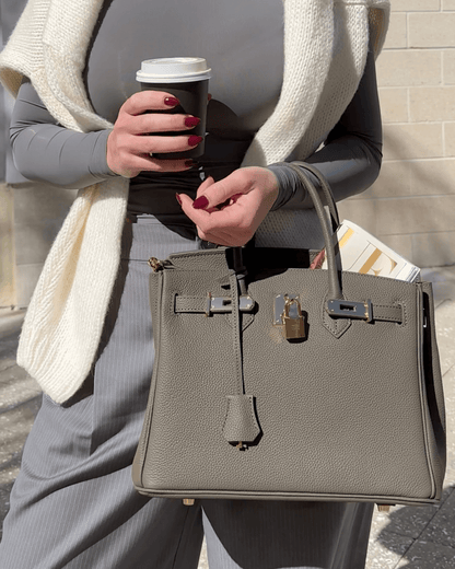 Synthetic leather handbag featuring a spacious interior and elegant design, perfect for organizing essentials for work and travel. 1