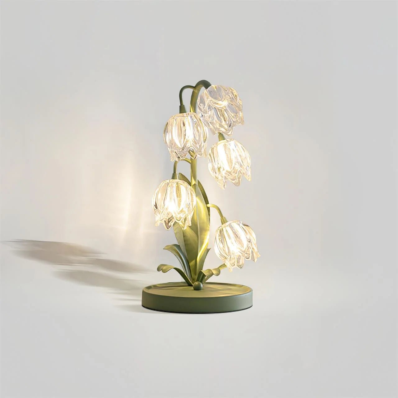 Table lamp featuring a delicate glass petal shade in vibrant colors, supported by a stylish green metal stem, designed for compact spaces at 37cm tall 0