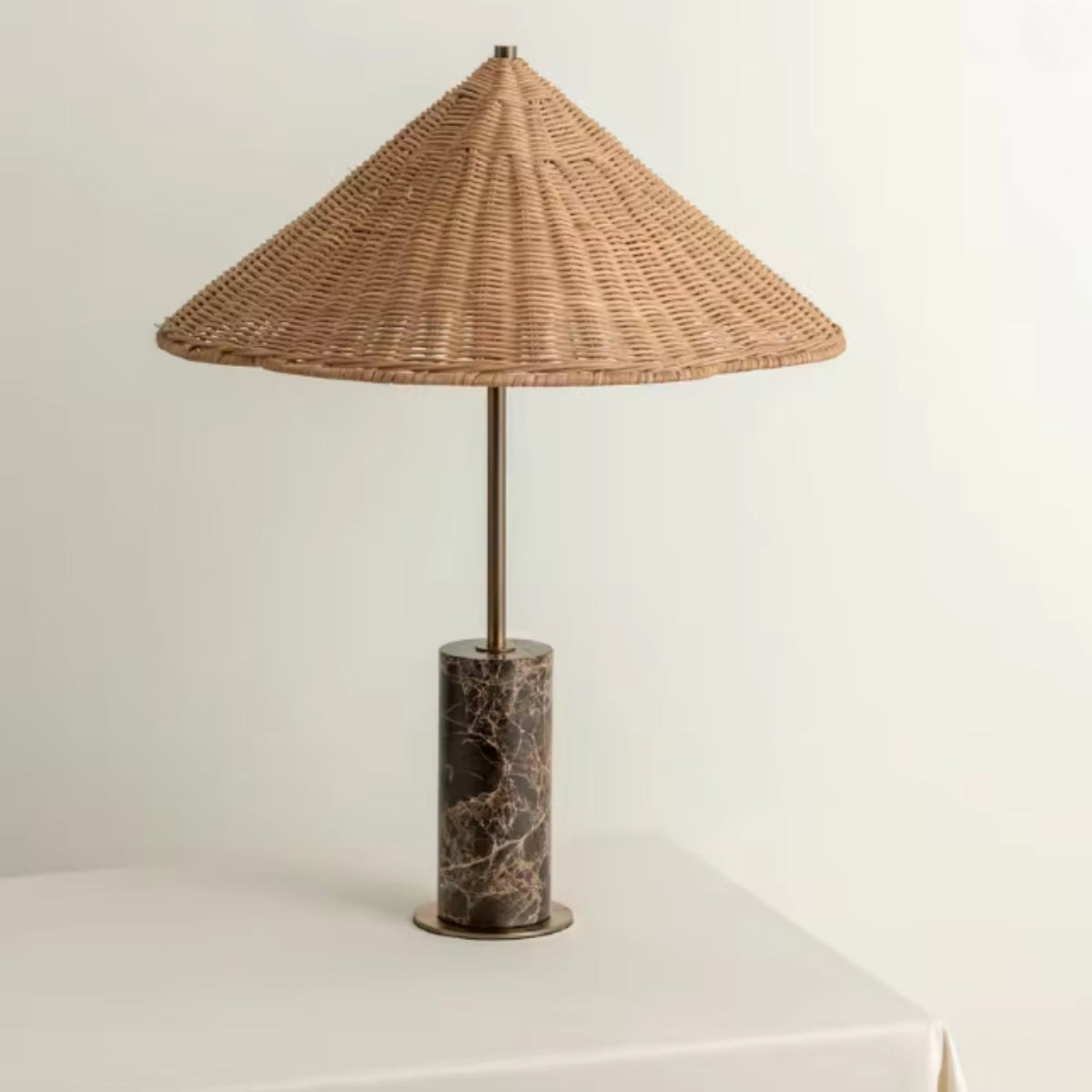 Table lamp featuring a handwoven rattan shade and a sleek marble base, embodying an organic modern design perfect for a bedroom or nightstand. 0