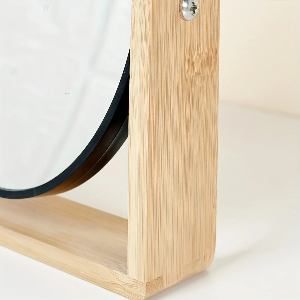 Tabletop makeup mirror featuring a double-sided rotating design with a magnifying side, elegantly framed in natural bamboo, perfect for a stylish vanity setup. 7