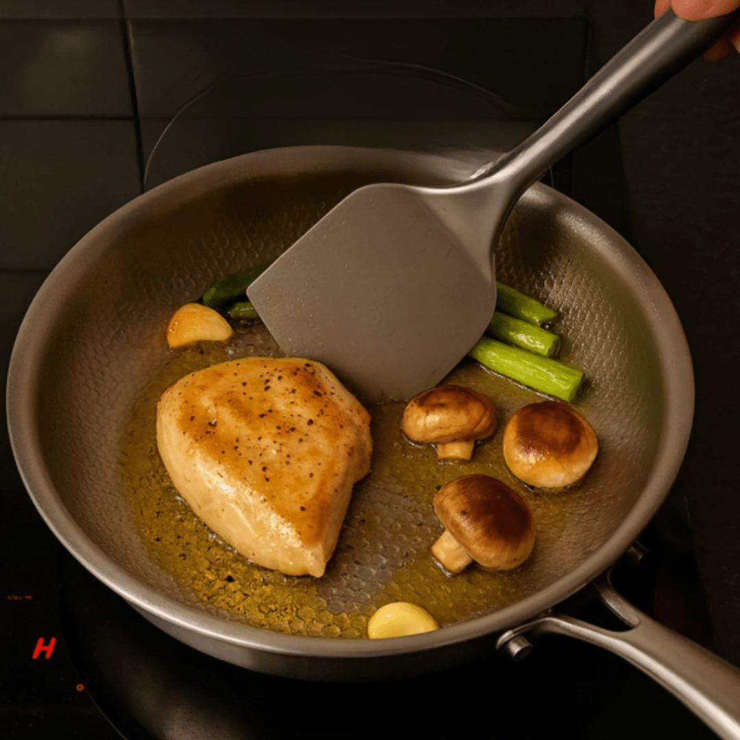 Titanium frying pan with a hammered finish in metallic silver, designed for induction cooking, providing durable construction and even heat distribution. 4