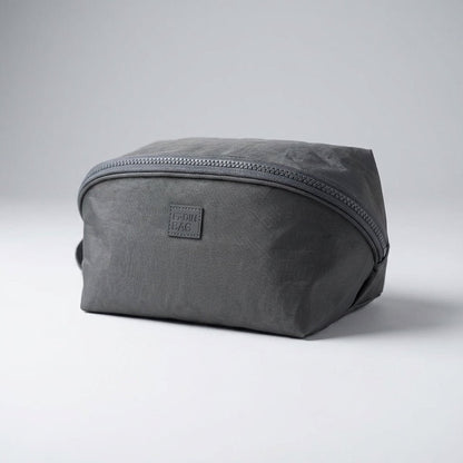 Light pink nylon travel toiletry bag featuring smart compartments and a wide opening, perfect for organizing cosmetics and personal care items while on the go. 7