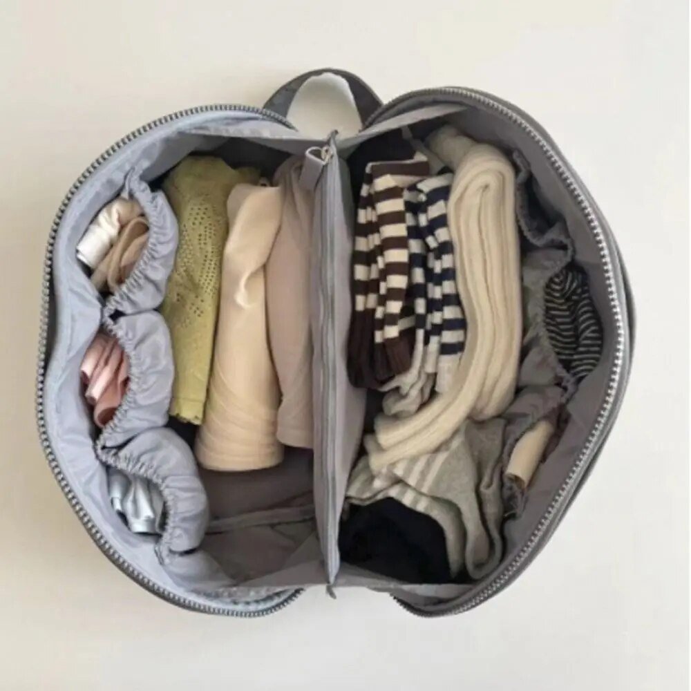 Light pink nylon travel toiletry bag featuring smart compartments and a wide opening, perfect for organizing cosmetics and personal care items while on the go. 6