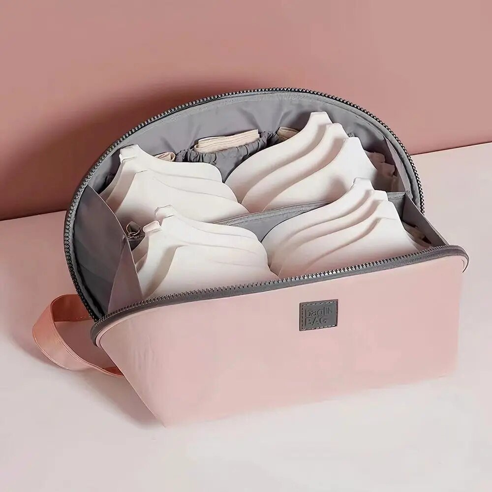 Light pink nylon travel toiletry bag featuring smart compartments and a wide opening, perfect for organizing cosmetics and personal care items while on the go. 5