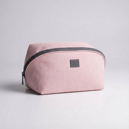 Light pink nylon travel toiletry bag featuring smart compartments and a wide opening, perfect for organizing cosmetics and personal care items while on the go. 0