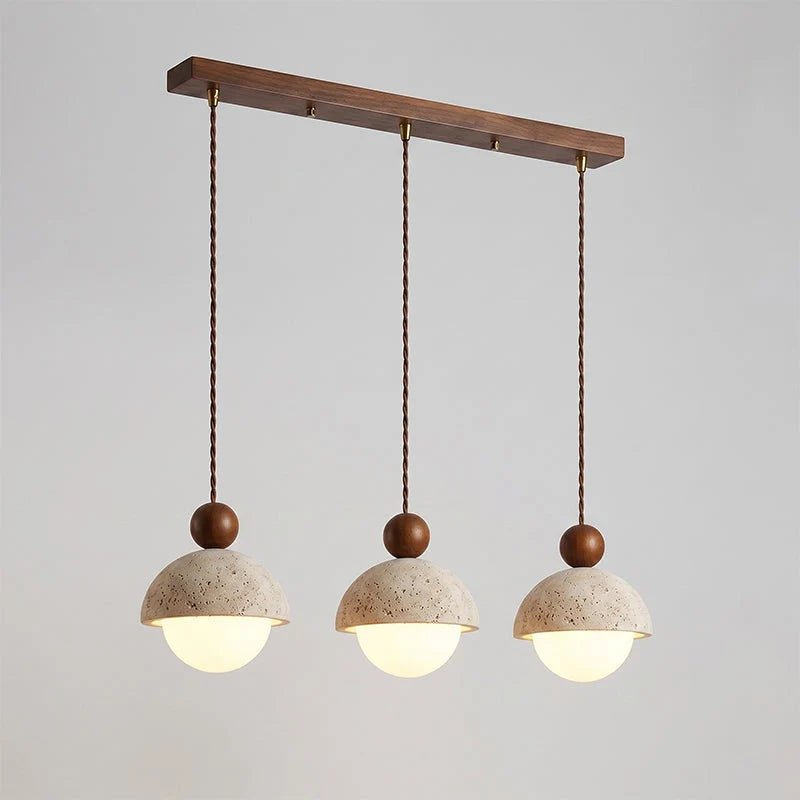 Travertine pendant light featuring a glass shade and wood accent, ideal for modern kitchen lighting over an island or dining table. 27