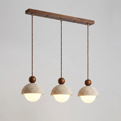 Travertine pendant light featuring a glass shade and wood accent, ideal for modern kitchen lighting over an island or dining table. 27