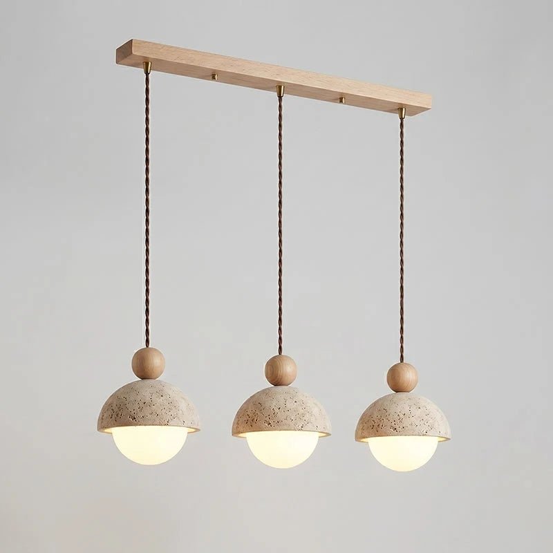 Travertine pendant light featuring a glass shade and wood accent, ideal for modern kitchen lighting over an island or dining table. 26