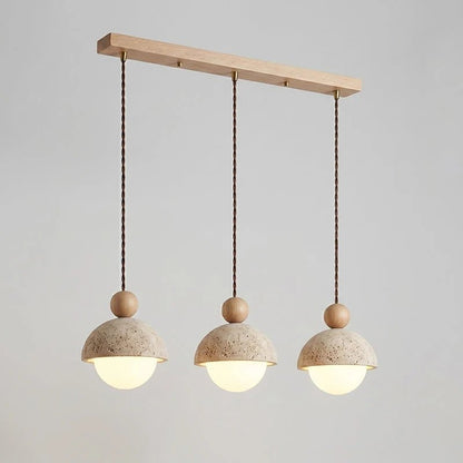 Travertine pendant light featuring a glass shade and wood accent, ideal for modern kitchen lighting over an island or dining table. 26