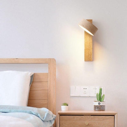 Travertine wall lamp featuring a swivel LED design with a minimalist stone and wood aesthetic, emitting a soft ivory light for elegant home decor. 6