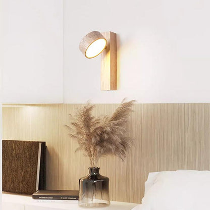 Travertine wall lamp featuring a swivel LED design with a minimalist stone and wood aesthetic, emitting a soft ivory light for elegant home decor. 2