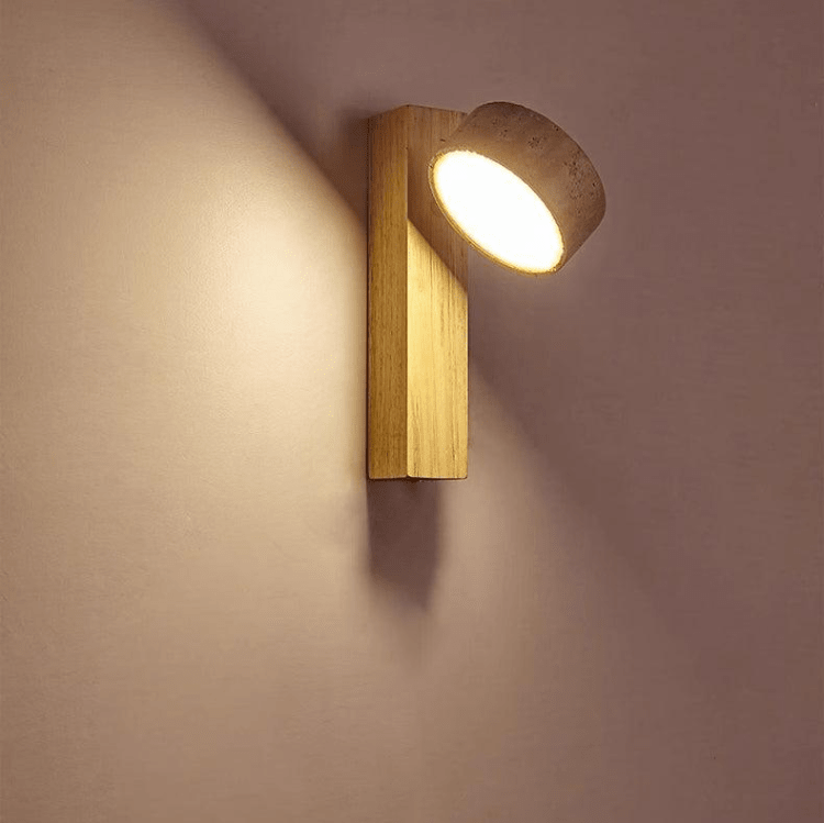 Travertine wall lamp featuring a swivel LED design with a minimalist stone and wood aesthetic, emitting a soft ivory light for elegant home decor. 1