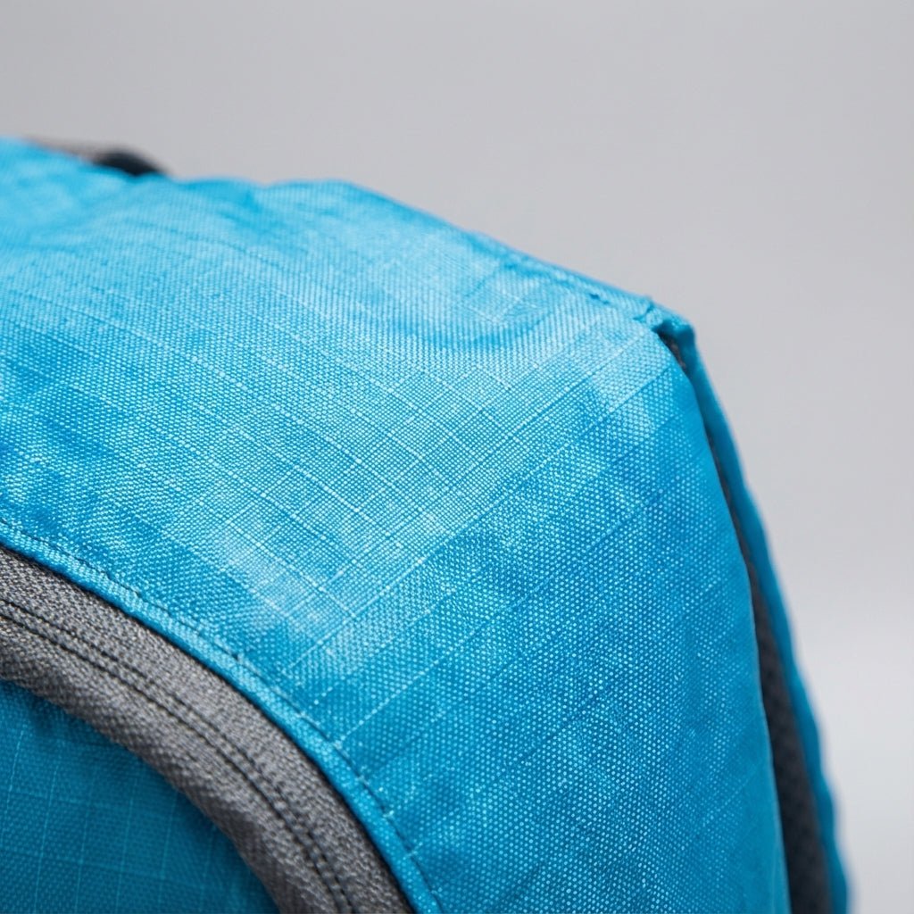 Ultralight travel backpack featuring water-resistant fabric, durable YKK zipper, and a compact foldable design, available in multiple colors. 3