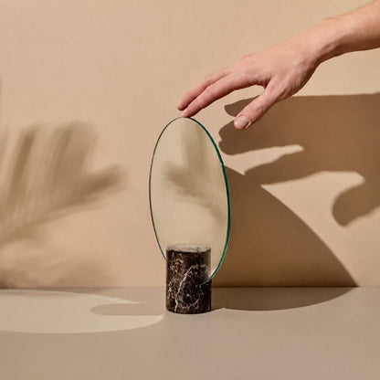 Vanity mirror with a frameless design and natural marble base, showcasing an elegant freestanding accent for modern home decor. 1