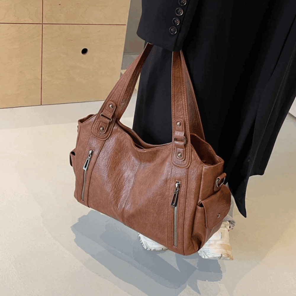 Vegan leather shoulder bag for women featuring a spacious interior and elegant metal accents, perfect for stylish and versatile everyday use. 2