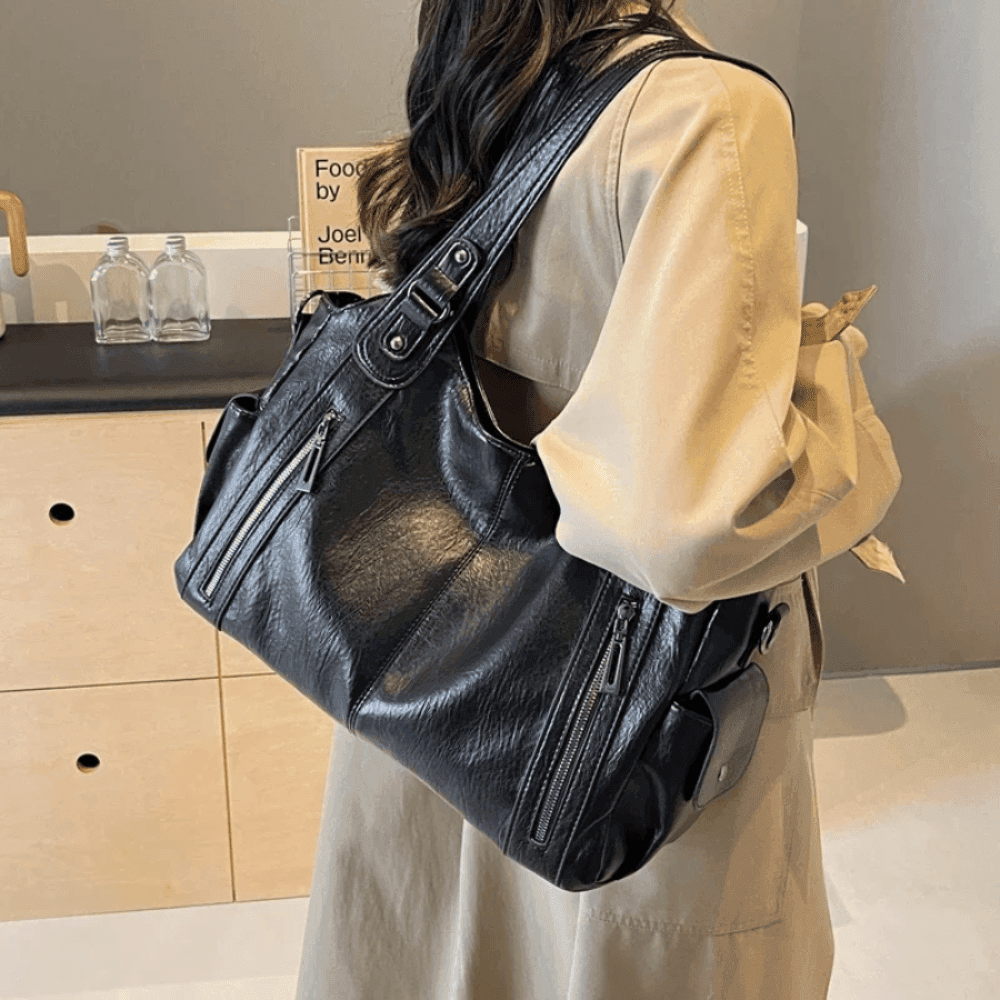 Vegan leather shoulder bag for women featuring a spacious interior and elegant metal accents, perfect for stylish and versatile everyday use. 1