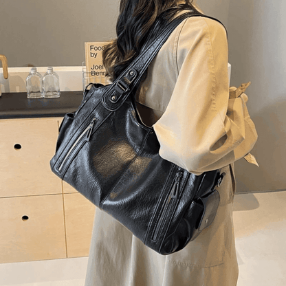 Vegan leather shoulder bag for women featuring a spacious interior and elegant metal accents, perfect for stylish and versatile everyday use. 1