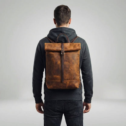 Vintage leather backpack featuring a spacious design, sturdy brass hardware, and a timeless aesthetic perfect for travel and everyday use. 1