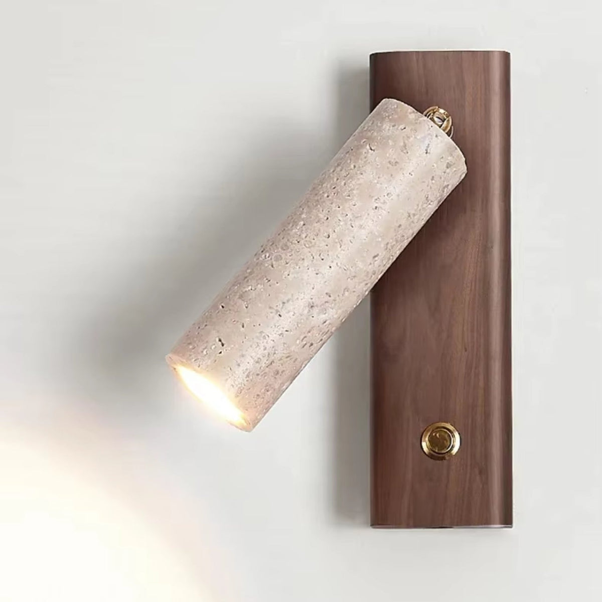 Wall lamp featuring an adjustable spotlight and crafted from natural travertine, showcasing a warm minimalist design ideal for modern interiors. 0