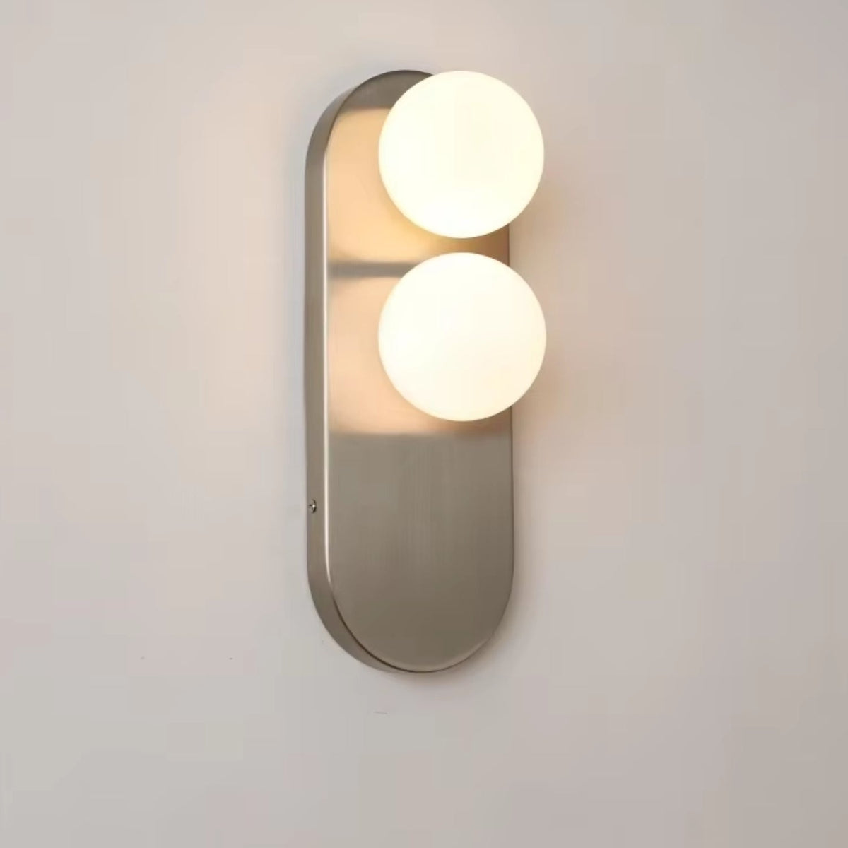 Modern vertical wall sconce featuring frosted glass globes and a sleek brushed nickel finish, perfect for contemporary home decor. 6