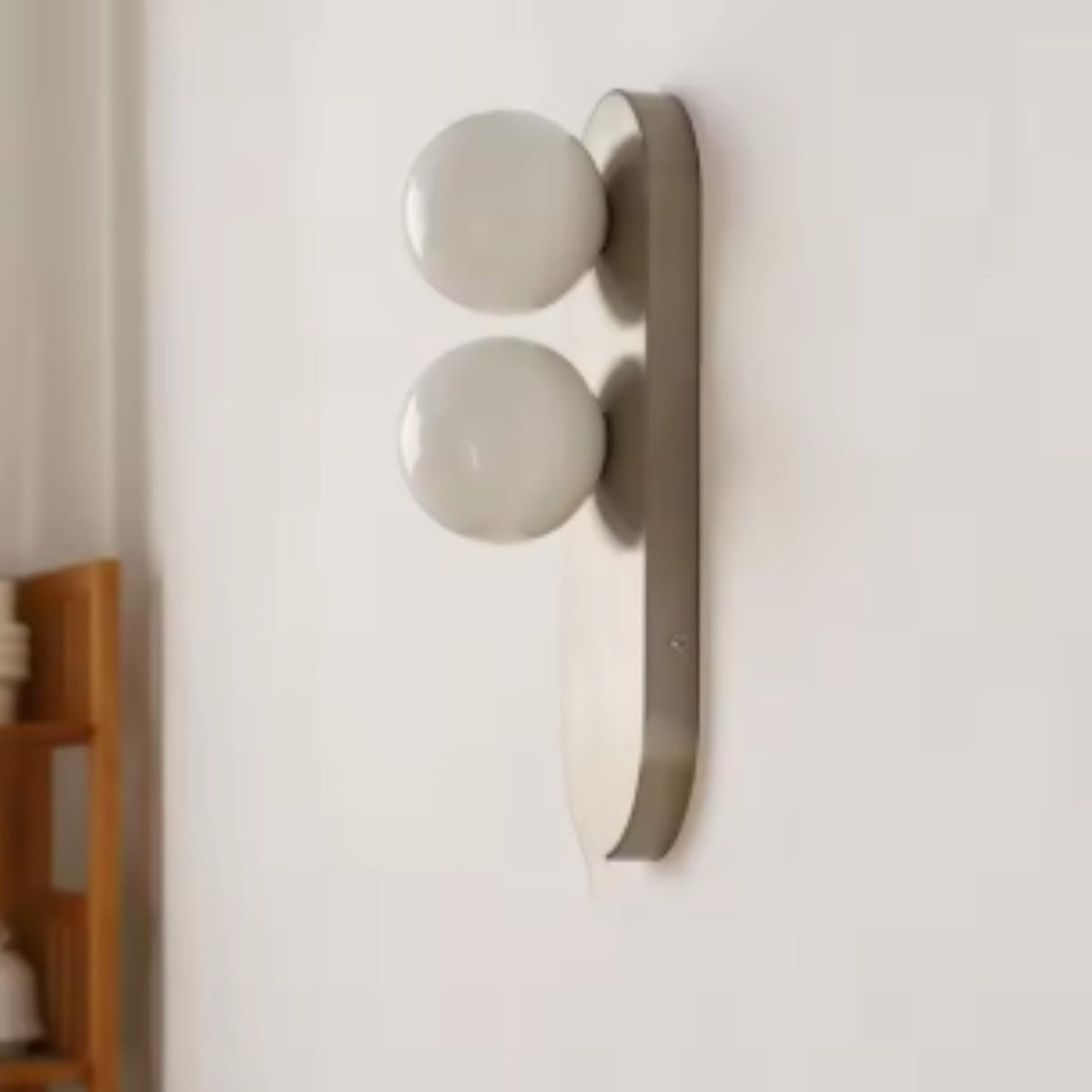 Modern vertical wall sconce featuring frosted glass globes and a sleek brushed nickel finish, perfect for contemporary home decor. 1