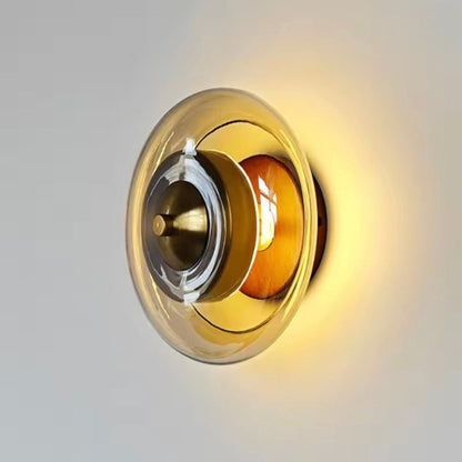 Wall lamp featuring integrated LED technology and elegant amber glass, designed for compact decorative lighting in modern interiors. 1