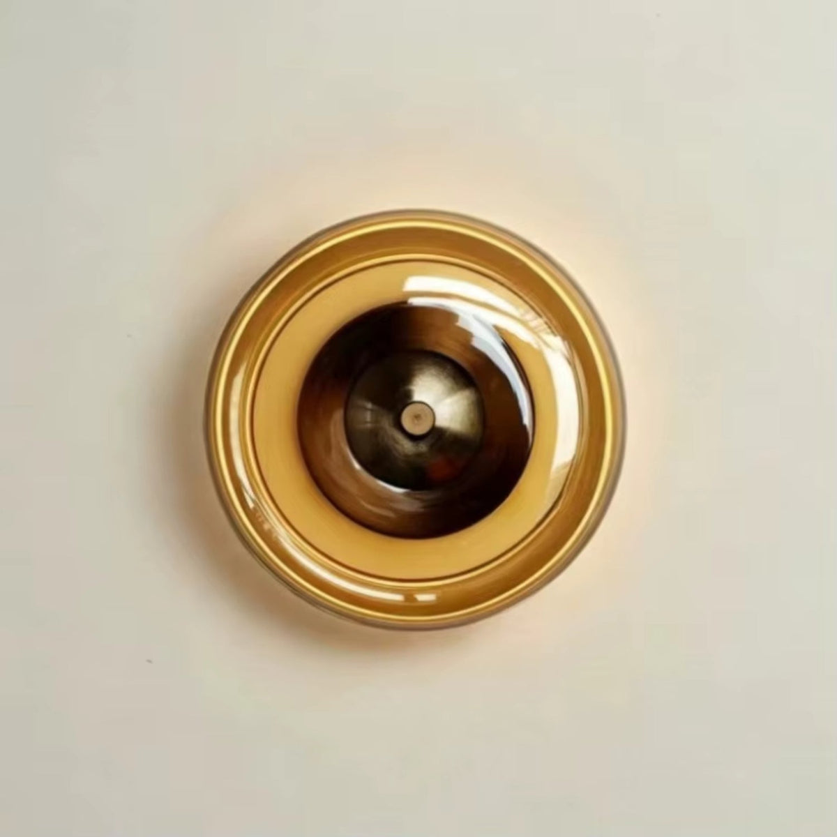 Wall lamp featuring integrated LED technology and elegant amber glass, designed for compact decorative lighting in modern interiors. 0
