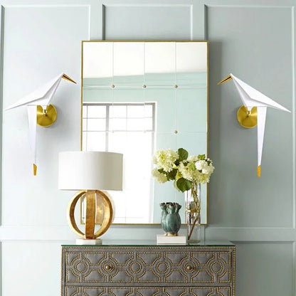 Wall lamp featuring warm LED lighting and a stylish matte gold finish, designed with a unique tap and paper motif, perfect for enhancing modern interiors. 2