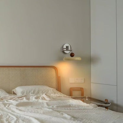 Modern minimalist wall light with adjustable arm, featuring a sleek metal and acrylic finish, perfect for contemporary home decor. 5