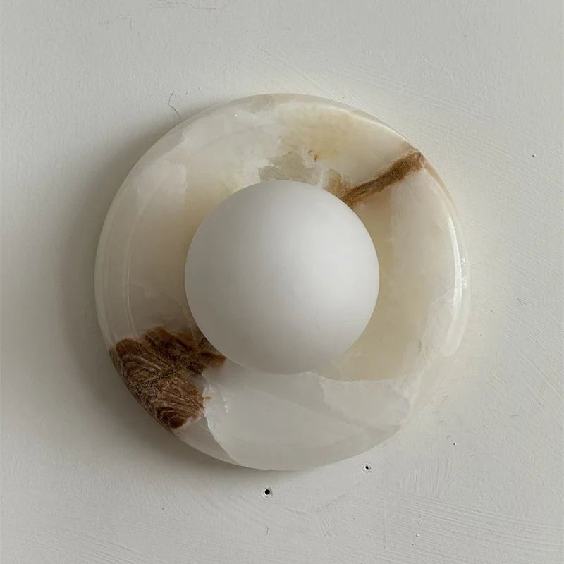 Wall light featuring a natural onyx backplate and a stylish glass globe, designed for hardwired indoor installation, perfect for enhancing home decor. 39