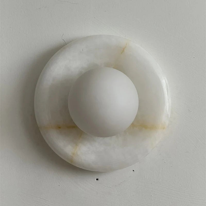 Wall light featuring a natural onyx backplate and a stylish glass globe, designed for hardwired indoor installation, perfect for enhancing home decor. 24