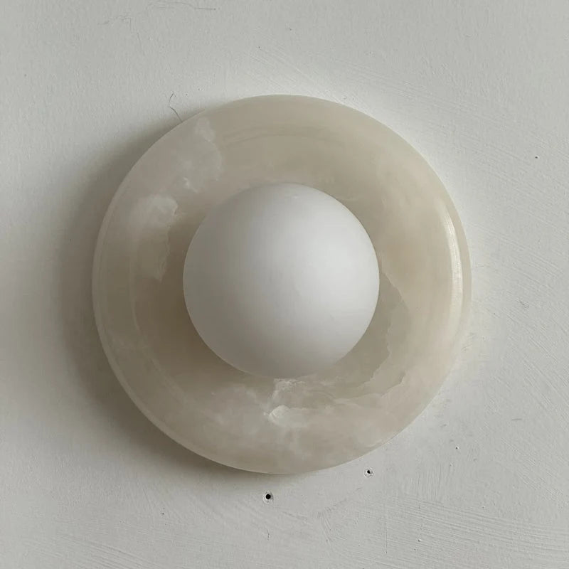 Wall light featuring a natural onyx backplate and a stylish glass globe, designed for hardwired indoor installation, perfect for enhancing home decor. 27