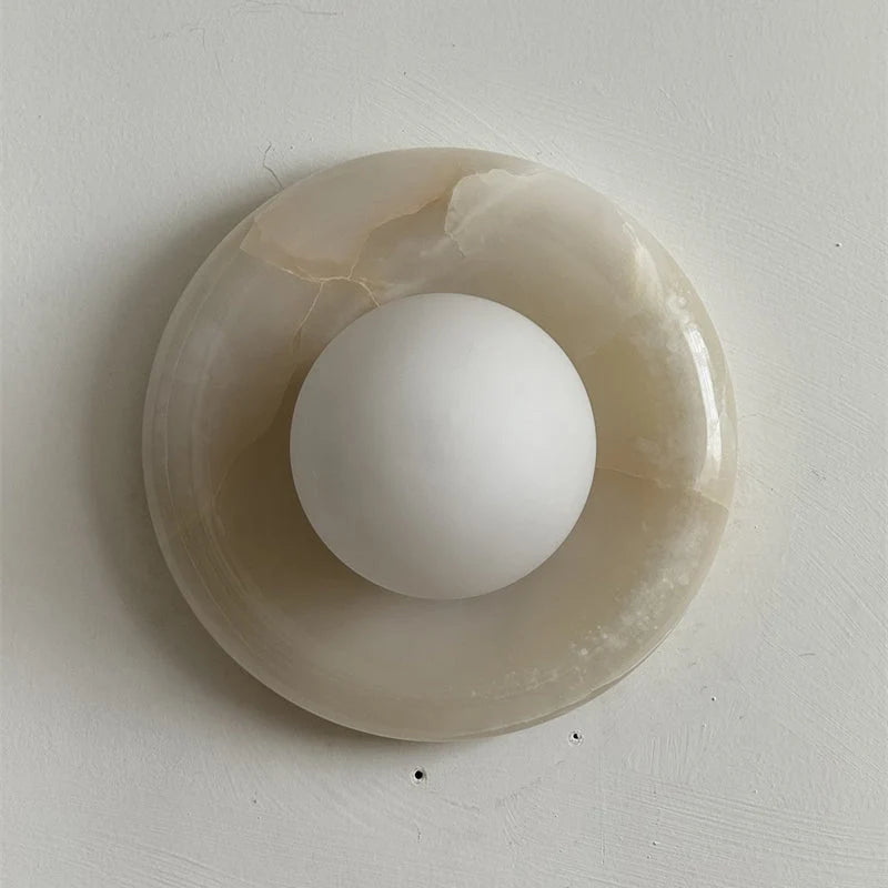 Wall light featuring a natural onyx backplate and a stylish glass globe, designed for hardwired indoor installation, perfect for enhancing home decor. 49