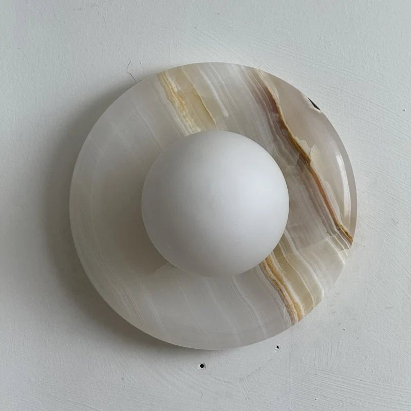Wall light featuring a natural onyx backplate and a stylish glass globe, designed for hardwired indoor installation, perfect for enhancing home decor. 47