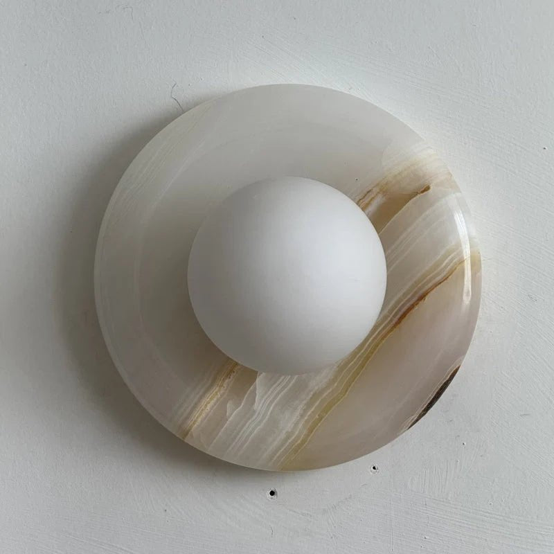 Wall light featuring a natural onyx backplate and a stylish glass globe, designed for hardwired indoor installation, perfect for enhancing home decor. 40
